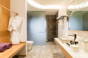 a bathroom with a sink and a toilet and a mirror at La Vida Samui in Chaweng