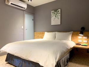 Voodi või voodid majutusasutuse Raise Hotel Taichung toas