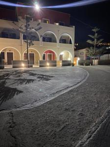 a large building at night with a driveway at Romantic Spa Resort in Fira