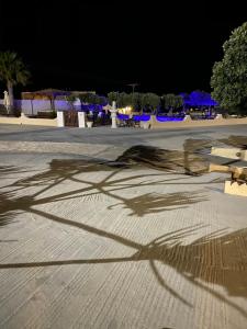 a shadow of a person riding a skateboard at night at Romantic Spa Resort in Fira