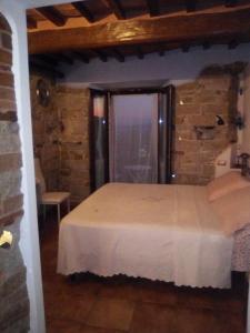 a bedroom with a bed in a room with a window at Monolocale romantico in Roccastrada