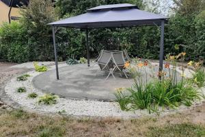 a tent and a table under a canopy in a garden at Apartmán Vintage A2 v Chomutově in Chomutov