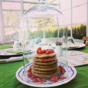 a stack of pancakes on a plate under a glass dome at Giardino della Moscatella in Altamura
