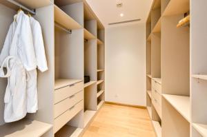a walk in closet with white closets at The Clouds Apartment in Shenzhen
