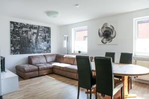 a living room with a couch and a table at Apartment "New York - Prag" in Korschenbroich