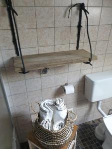 a bathroom with a basket of shoes on a wall at Studio 11 in Neuffen