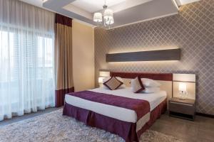 Un pat sau paturi într-o cameră la New Splendid Hotel & Spa - Adults Only (+16)