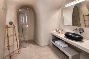 a bathroom with a black sink and a shower at Hill Suites in Fira +83 photos