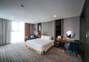 Postel nebo postele na pokoji v ubytování Muong Thanh Luxury Saigon Hotel