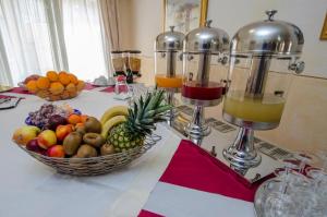 a table topped with fruit and three wine glasses at AIR La Casa di Gio' in Isola Rossa