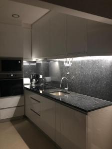 a kitchen with a sink and a counter top at Casa da Ponte de Pedra in Aljezur