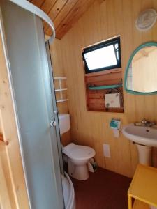 a small bathroom with a toilet and a sink at Bohema Osada in Łazy