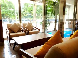 a living room with couches and a coffee table at Hotel Peace Island Nago in Nago