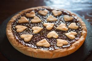 a chocolate pie with heart shaped cookies on top at Agriturismo Grossola in Castiglione dʼOrcia