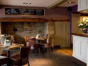 a restaurant with tables and chairs and a chalkboard on the wall at Tilted Wig in Warwick