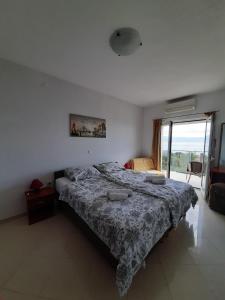 a bedroom with a bed and a large window at Villa Kubo in Lovran