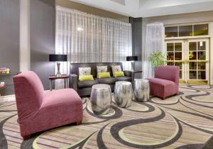 a living room with a couch and two chairs at La Quinta by Wyndham Dallas North Central in Dallas