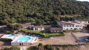 an aerial view of a house with a swimming pool at Hotel Valkarana Country Relais in Sant Antonio Di Gallura