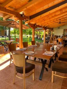 a large wooden table and chairs in a restaurant at Lazar Winery Tourism B&B in Rosoman