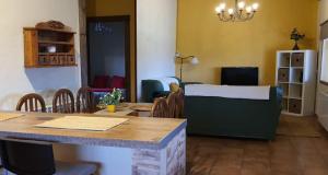 a room with a table and chairs and a living room at casa Rural Las Traviesas in Candeleda