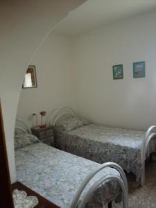 a room with two beds in a room at Trulli di nonno Ciccio in Cisternino