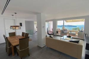 a dining room and living room with a couch and a table at Casa Paradiso Tropical in La Herradura