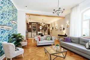 a living room with a couch and a table at Riga Old Town Jāņa Sēta Residence in Riga