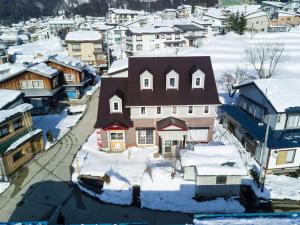 an aerial view of a town in the snow at Akari House Swiss Bakery in Nozawa Onsen