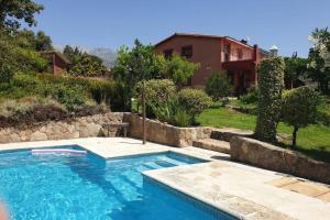 a swimming pool in front of a house at CASA RURAL LAS TRAVIESAS 2 in Candeleda