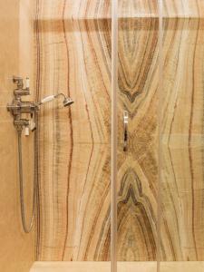 a shower in a bathroom with a wooden wall at Cà Bellavista in Venice