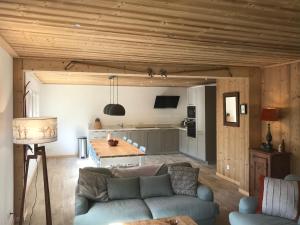 a living room with a couch and a kitchen at La Maison du Hérisson in Samoëns