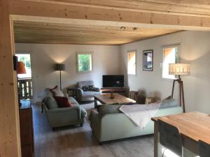 a living room with two couches and a table at La Maison du Hérisson in Samoëns