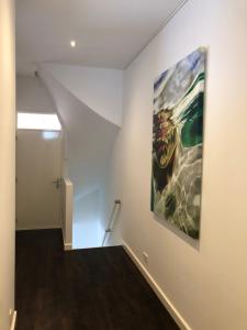 a hallway with a painting on the wall at Pension Montmaertre in Zierikzee