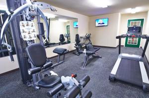 a gym with treadmills and machines in a room at Savannah Suites Atlanta Airport in Atlanta
