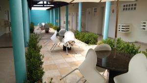 a group of tables and chairs in a building at Village Hotel Belém in Belém de São Francisco