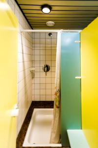 a bathroom with a shower with a bath tub at Jugendherberge Regensburg in Regensburg