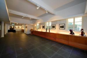 a large room with a hallway with pictures on the wall at 饒宗頤文化館 - 翠雅山房 in Hong Kong