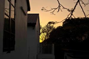a building with the sunset in the background at 饒宗頤文化館 - 翠雅山房 in Hong Kong