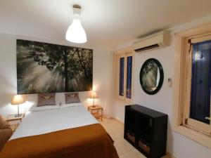 a bedroom with a bed and a large painting on the wall at Corazón de Madrid in Madrid