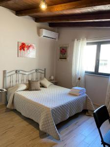 a bedroom with a bed and a window at LA PICCOLA DEPENDANCE in Tuscania