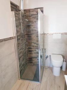 a bathroom with a shower and a toilet at LA PICCOLA DEPENDANCE in Tuscania