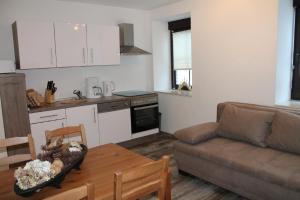 a kitchen and a living room with a couch and a table at FW Kleine Kirchgasse in Annaberg-Buchholz