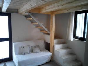 グラネッリにあるCasa Vacanza al Mare Villa Adrianaの階段とソファ(枕付)が備わる客室です。