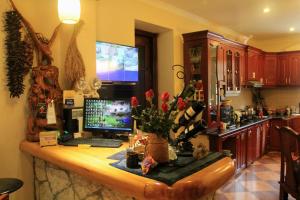 a kitchen with a desk with a computer on it at Sapa Garden Bed and Breakfast in Sapa
