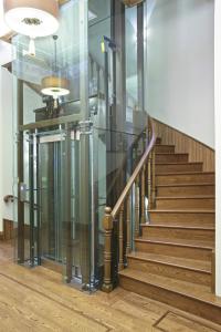 a glass elevator in a building with stairs at Celine Hotel - Ottoman Mansion in Istanbul