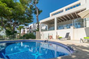 a swimming pool in front of a house at Cala Llonga in Santanyi