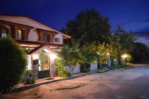 a house with lights on a driveway at night at Family Villa Kalypso in Oreoi