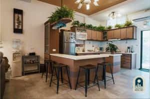 a kitchen with a bar with stools in it at House 303 小阿姨的家民宿 in Hualien City