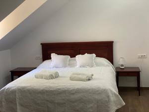 a bedroom with a bed with two towels on it at Kuća za odmor "Villa Oliva" in Ivan Dolac +6 photos