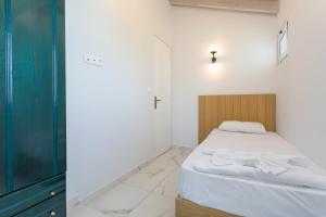 a bedroom with a bed with a wooden head board at Kouros Hill in Xirokástellon